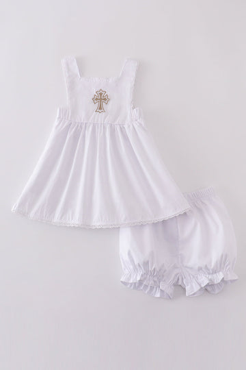 Soft, white romper with delicate cross embroidery, perfect for cozy playtime.