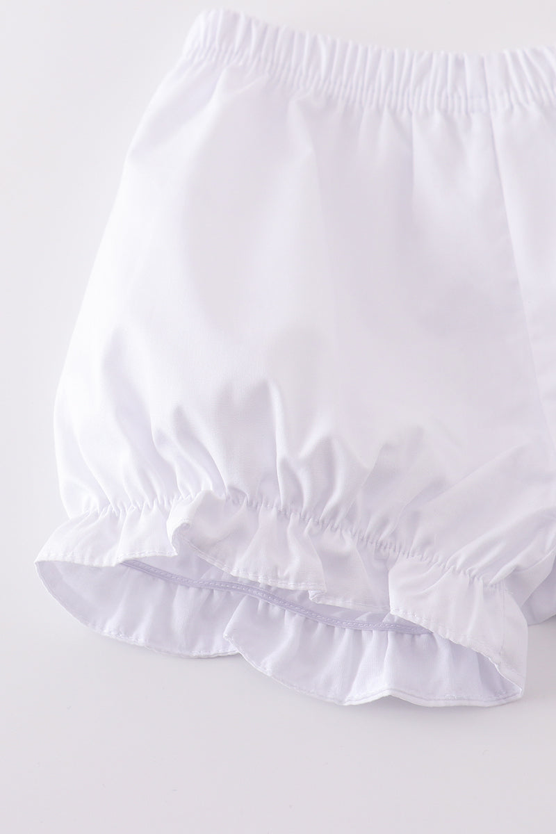 Soft, white romper with delicate cross embroidery, perfect for cozy playtime.
