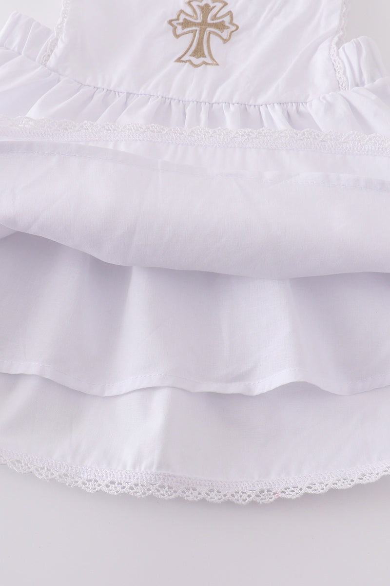 Soft, white romper with delicate cross embroidery, perfect for cozy playtime.