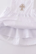 Soft, white romper with delicate cross embroidery, perfect for cozy playtime.