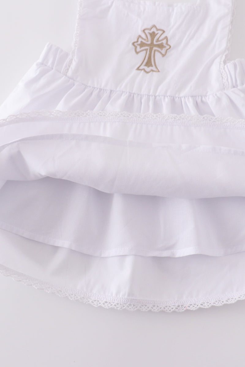 Soft, white romper with delicate cross embroidery, perfect for cozy playtime.