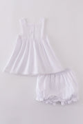 Soft, white romper with delicate cross embroidery, perfect for cozy playtime.