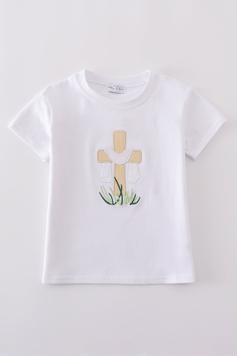 A cozy, white top with charming cross embroidery, perfect for playful adventures.