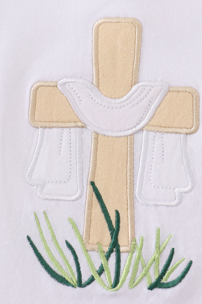 A cozy, white top with charming cross embroidery, perfect for playful adventures.