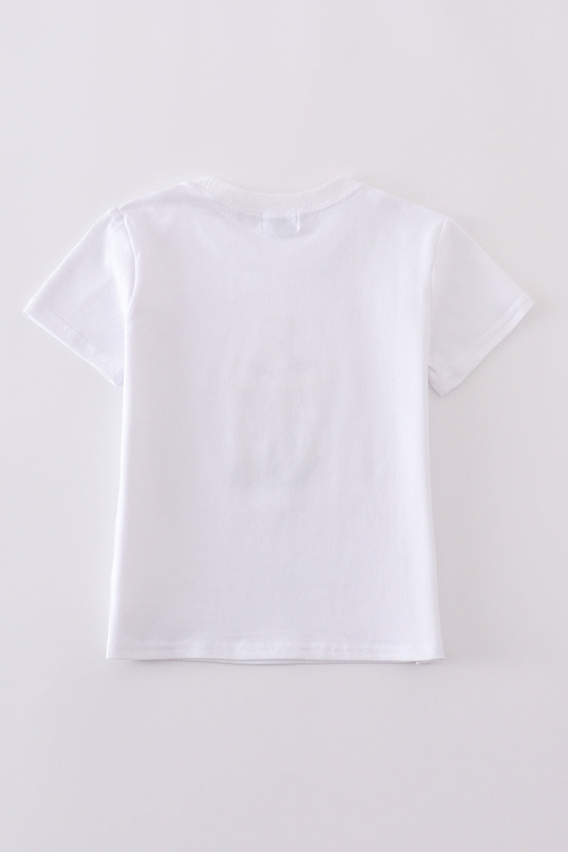 A cozy, white top with charming cross embroidery, perfect for playful adventures.