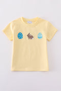 Warm mustard-colored children's top featuring a cute bunny and egg embroidery.