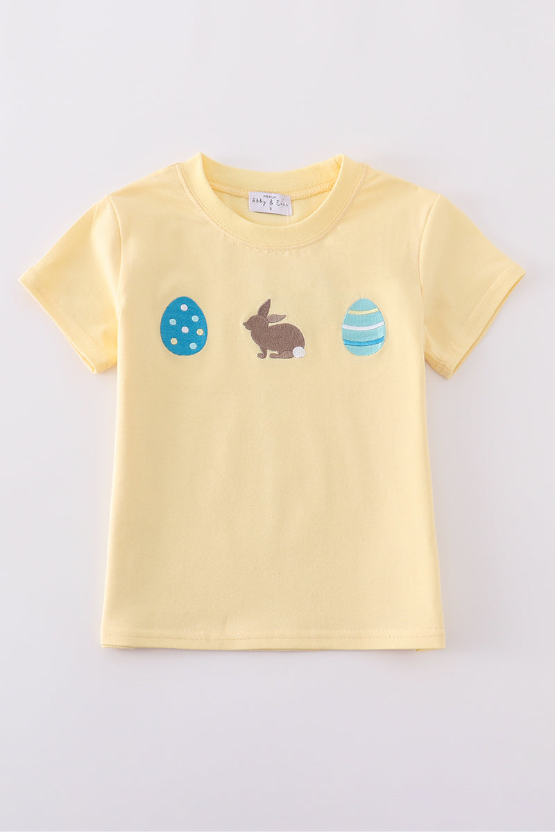 Warm mustard-colored children's top featuring a cute bunny and egg embroidery.