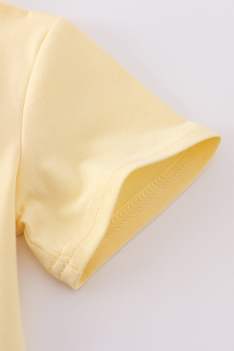 Warm mustard-colored children's top featuring a cute bunny and egg embroidery.