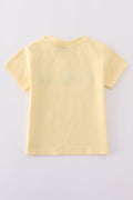 Warm mustard-colored children's top featuring a cute bunny and egg embroidery.