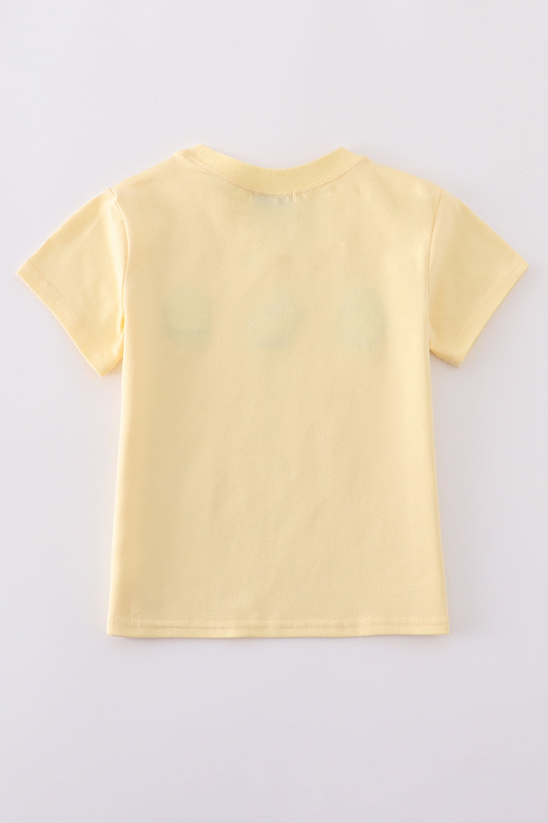 Warm mustard-colored children's top featuring a cute bunny and egg embroidery.