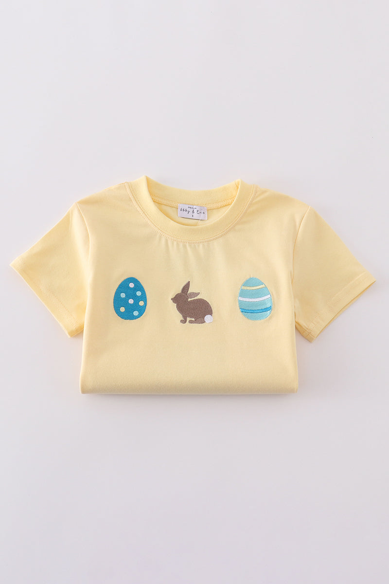 Warm mustard-colored children's top featuring a cute bunny and egg embroidery.