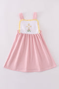 A charming pink dress with delicate cross embroidery, perfect for special occasions.