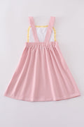 A charming pink dress with delicate cross embroidery, perfect for special occasions.