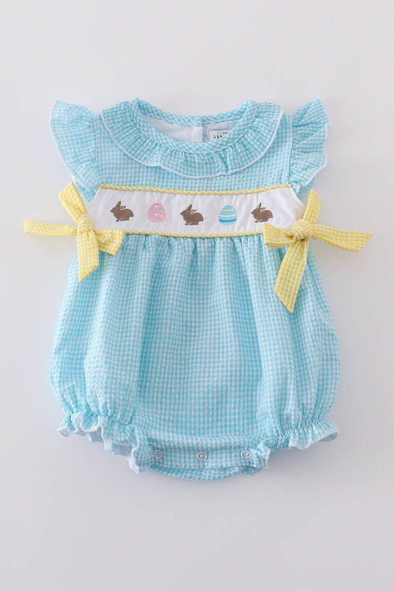 A mint gingham bubble romper with cute bunny and egg embroidery.