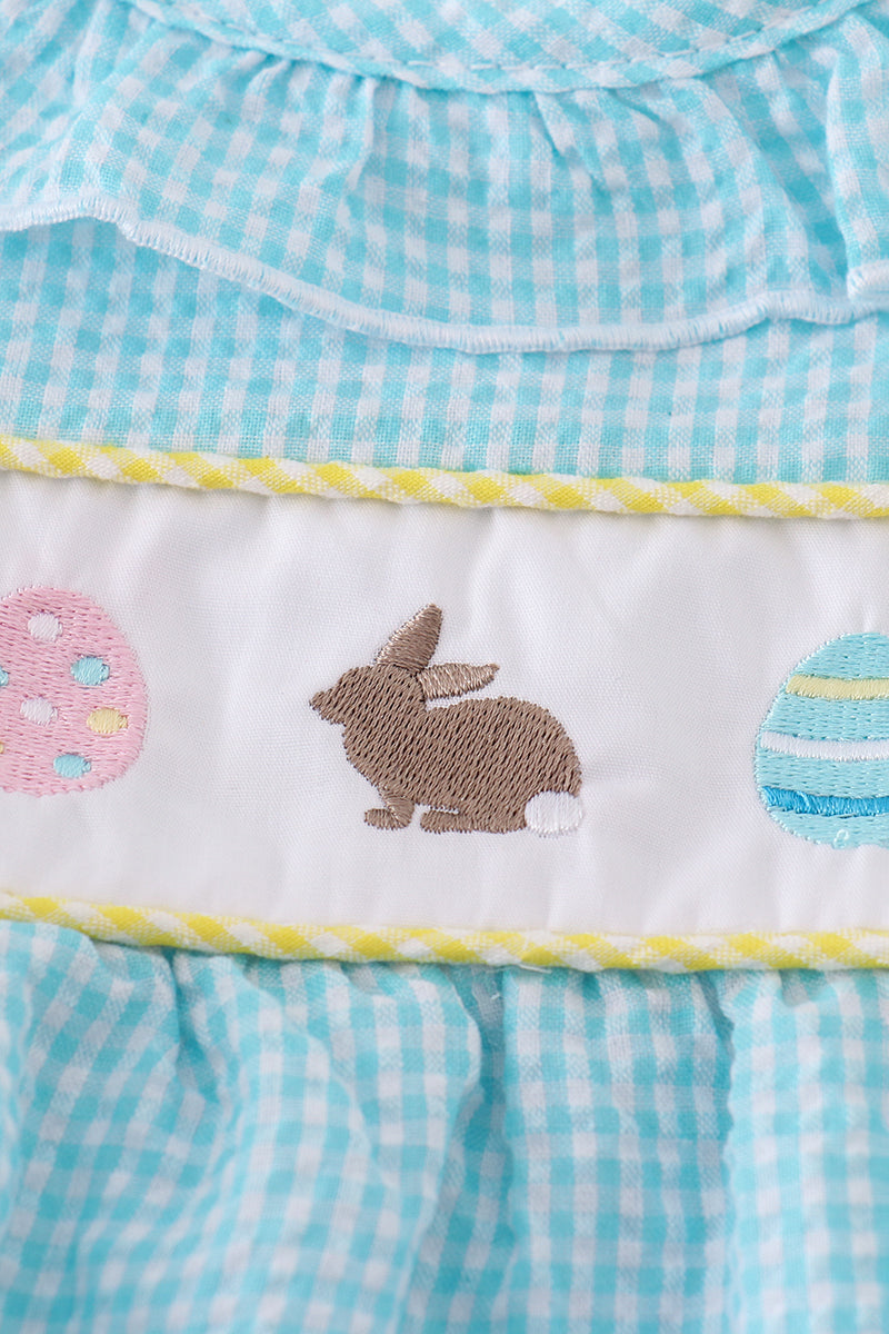 A mint gingham bubble romper with cute bunny and egg embroidery.