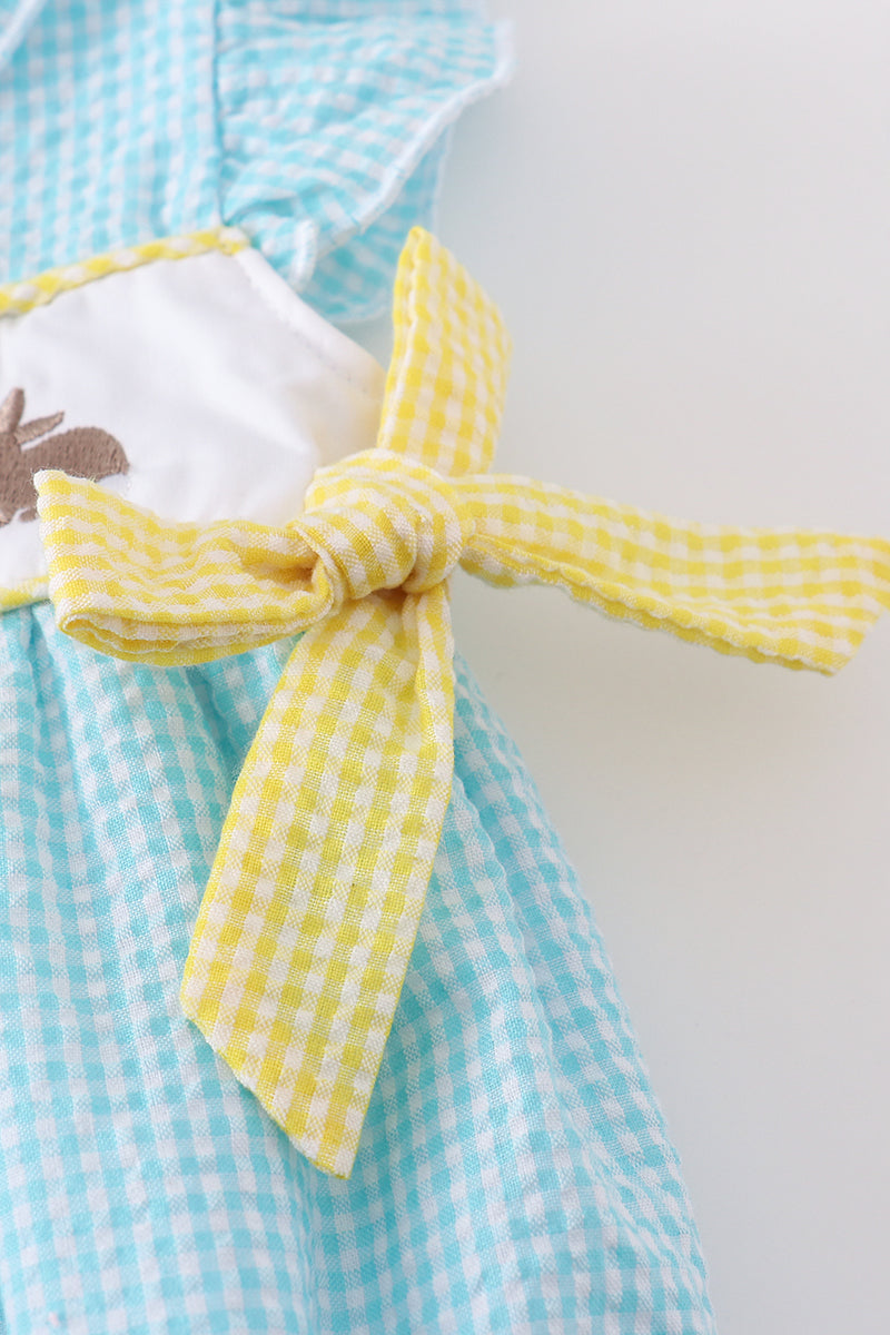 A mint gingham bubble romper with cute bunny and egg embroidery.