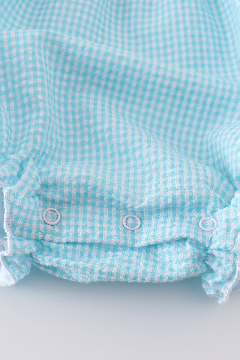 A mint gingham bubble romper with cute bunny and egg embroidery.