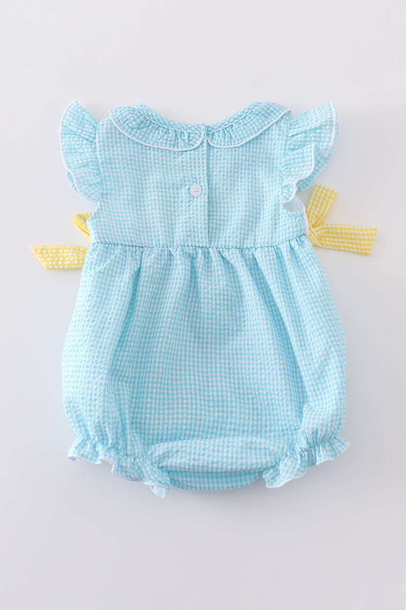 A mint gingham bubble romper with cute bunny and egg embroidery.