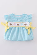 A mint gingham bubble romper with cute bunny and egg embroidery.
