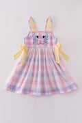 A charming pink plaid dress with bunny bow accents, perfect for springtime fun.