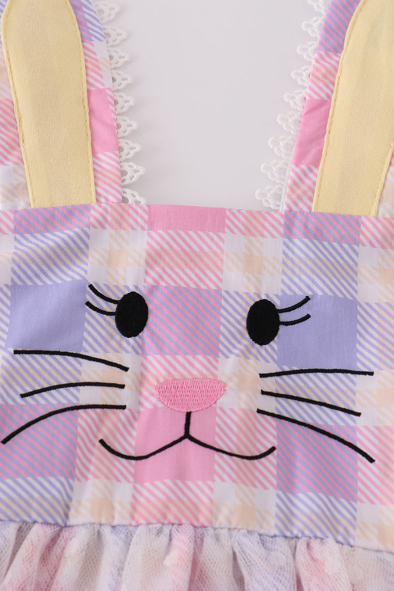 A charming pink plaid dress with bunny bow accents, perfect for springtime fun.