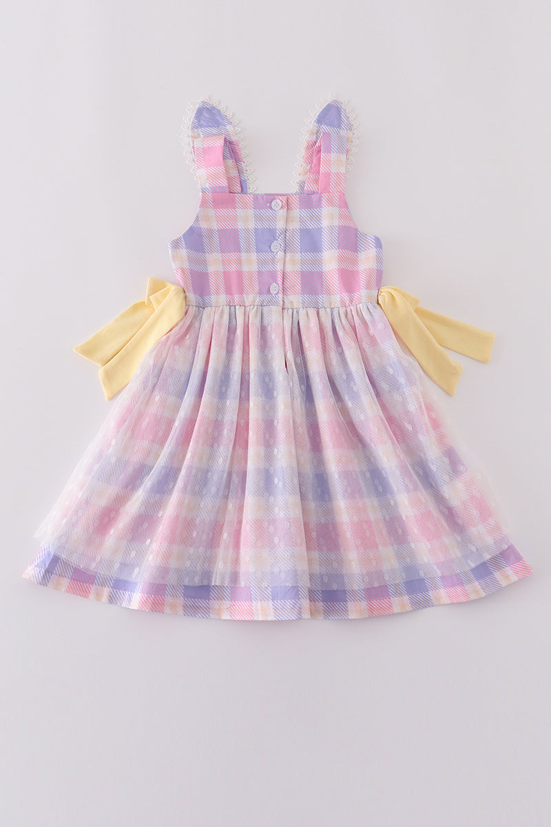 A charming pink plaid dress with bunny bow accents, perfect for springtime fun.