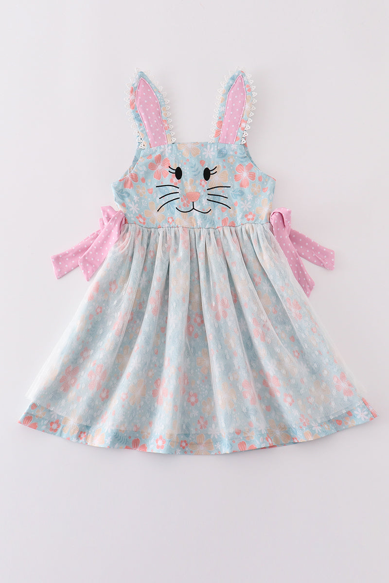 A charming green floral dress with bunny bow, perfect for springtime adventures.