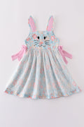 A charming green floral dress with bunny bow, perfect for springtime adventures.