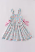 A charming green floral dress with bunny bow, perfect for springtime adventures.