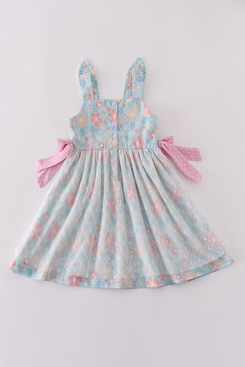 A charming green floral dress with bunny bow, perfect for springtime adventures.