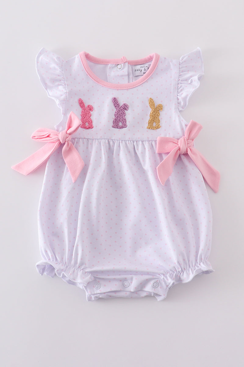 A charming pink bubble romper with bunny print and a cute bow.