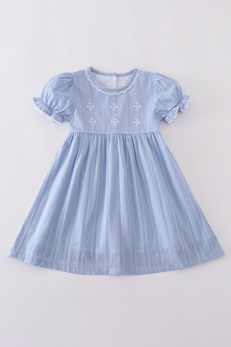 A charming blue dress with delicate cross embroidery, perfect for special occasions.