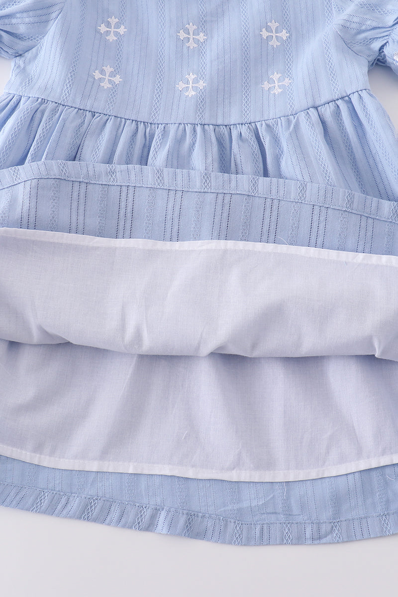 A charming blue dress with delicate cross embroidery, perfect for special occasions.