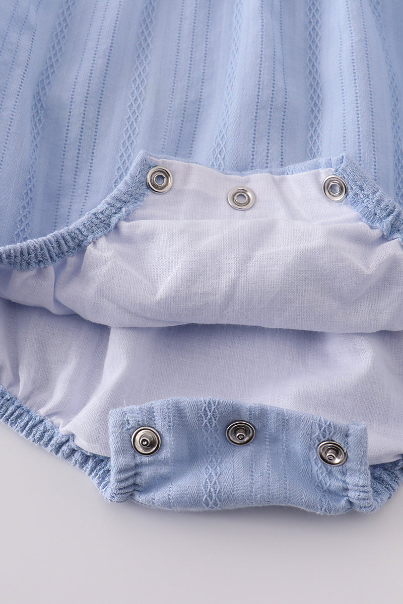 Premium blue bubble romper with charming cross embroidery, perfect for special occasions.
