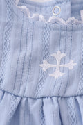 Premium blue bubble romper with charming cross embroidery, perfect for special occasions.