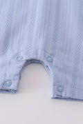 Cozy blue romper with charming cross embroidery, perfect for playful adventures.