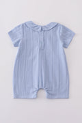 Cozy blue romper with charming cross embroidery, perfect for playful adventures.