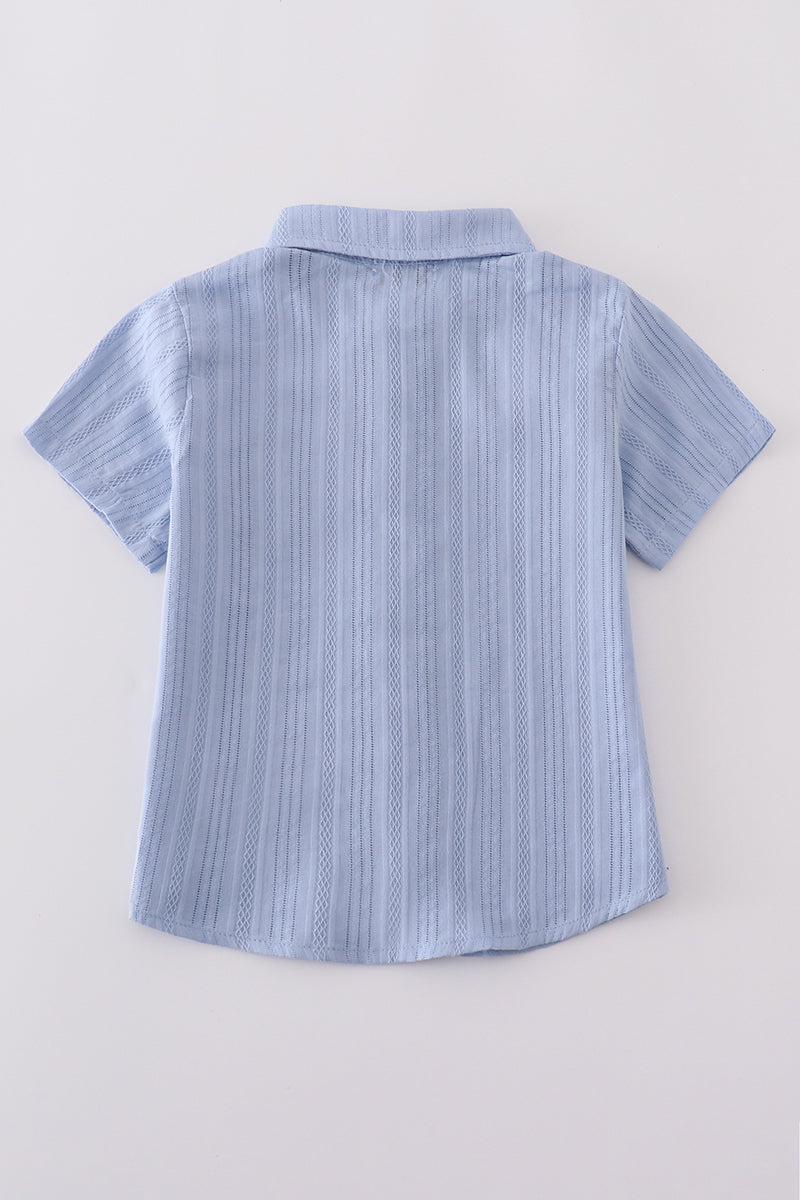 A charming blue button-down shirt with cross embroidery, perfect for kids.