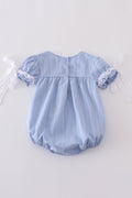A cozy blue bubble romper with charming cross embroidery, perfect for playtime.