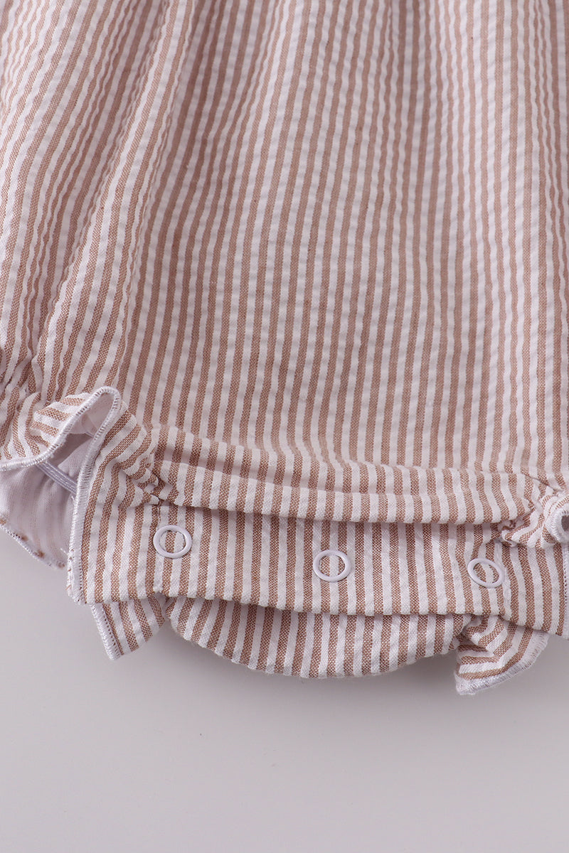 Premium brown bubble romper with charming cross embroidery, perfect for cozy playtime.
