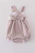 Premium brown bubble romper with charming cross embroidery, perfect for cozy playtime.