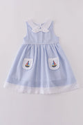 Premium blue dress with sailboat embroidery, perfect for a sunny day adventure.