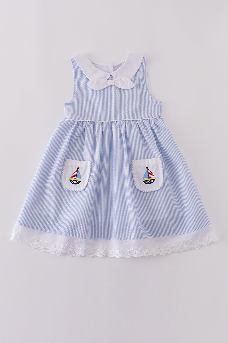 Premium blue dress with sailboat embroidery, perfect for a sunny day adventure.