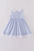 Premium blue dress with sailboat embroidery, perfect for a sunny day adventure.