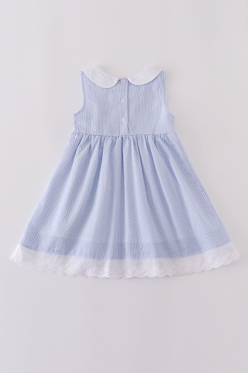 Premium blue dress with sailboat embroidery, perfect for a sunny day adventure.