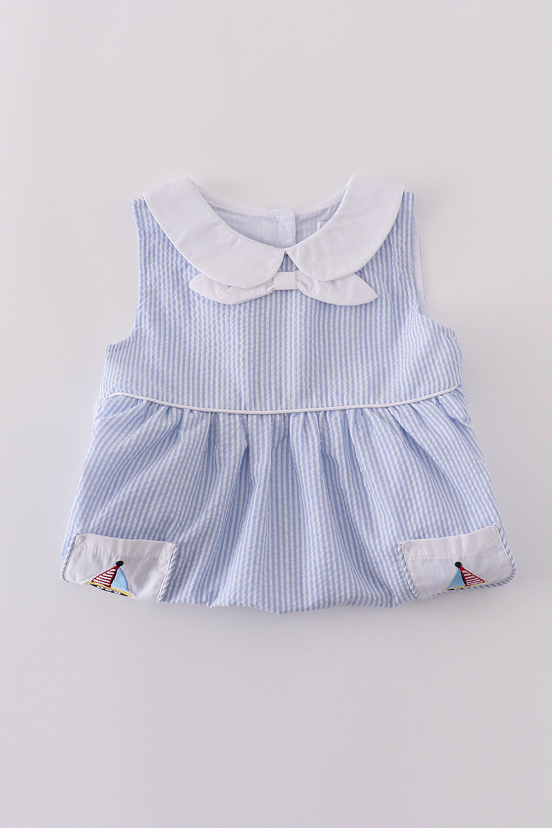 Premium blue dress with sailboat embroidery, perfect for a sunny day adventure.
