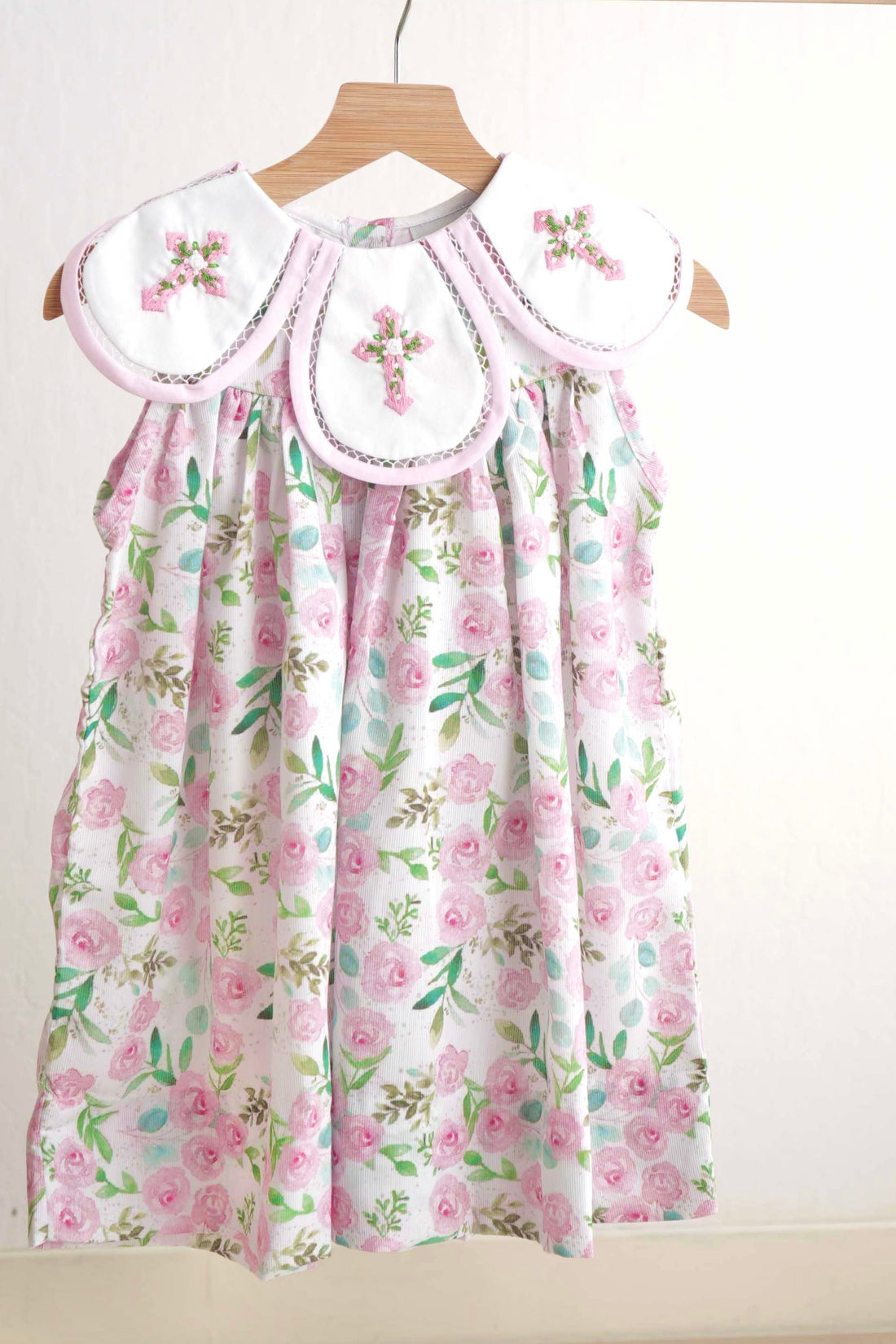 Pink Easter dress with floral embroidery and cross design, perfect for girls.