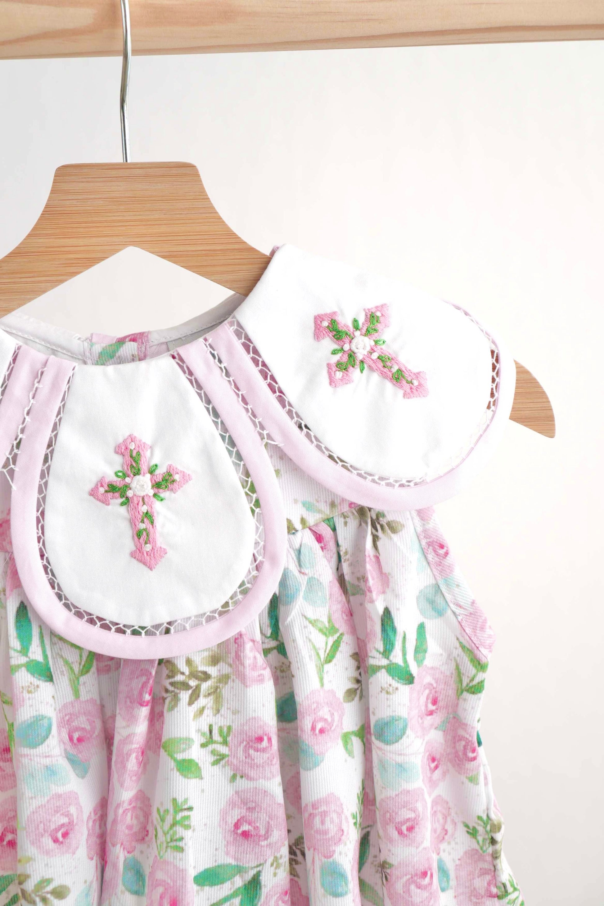 Pink Easter dress with floral embroidery and cross design, perfect for girls.