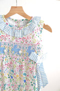Floral Easter bunny hand-smocked girl bubble with pastel colors and ruffled sleeves.