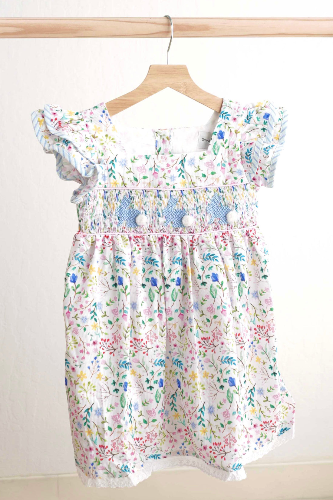 Floral Easter bunny hand-smocked dress with pastel colors and puffed sleeves.